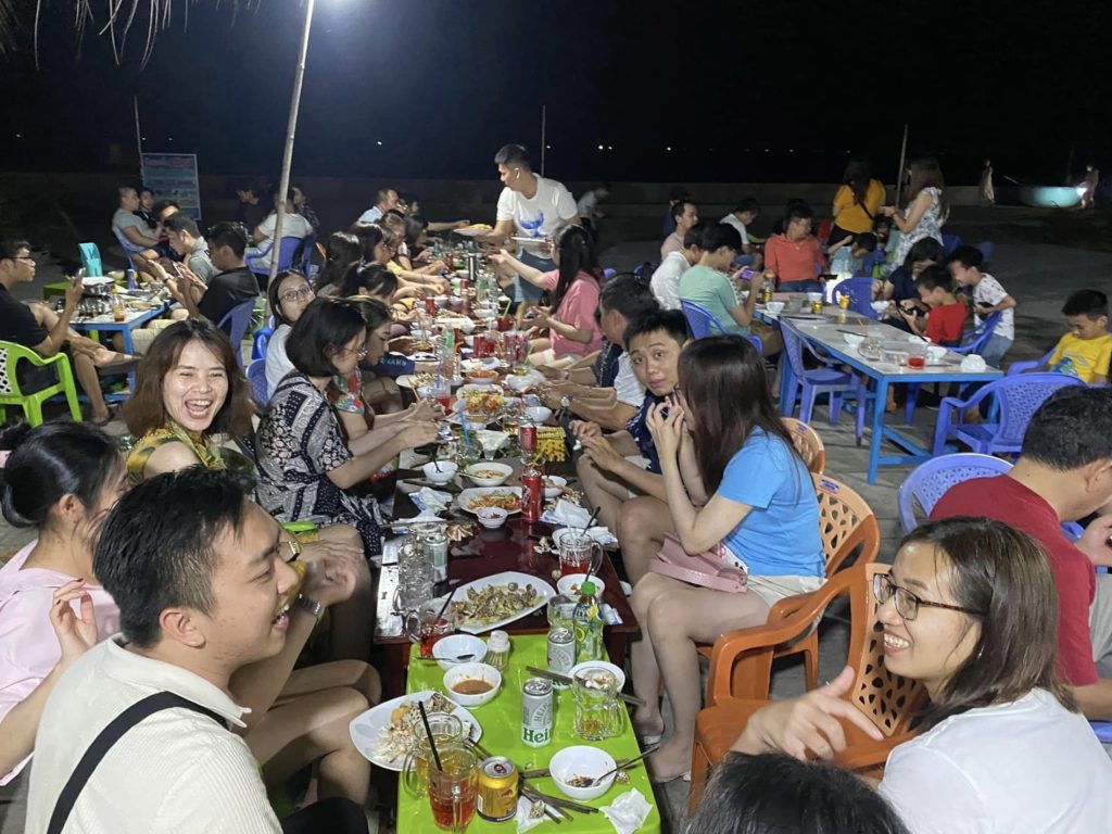 Guests enjoying seafood dinner at night