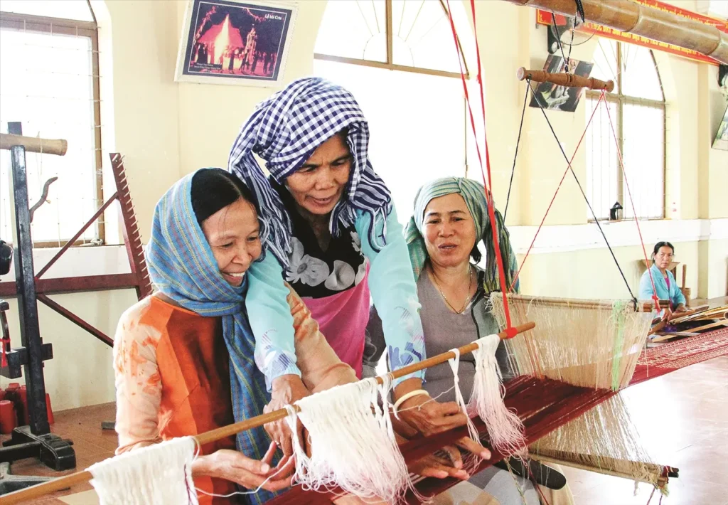 Cham artisan working on a traditional wooden loom