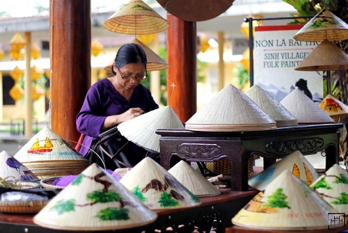 Local artisans crafting conical hats
